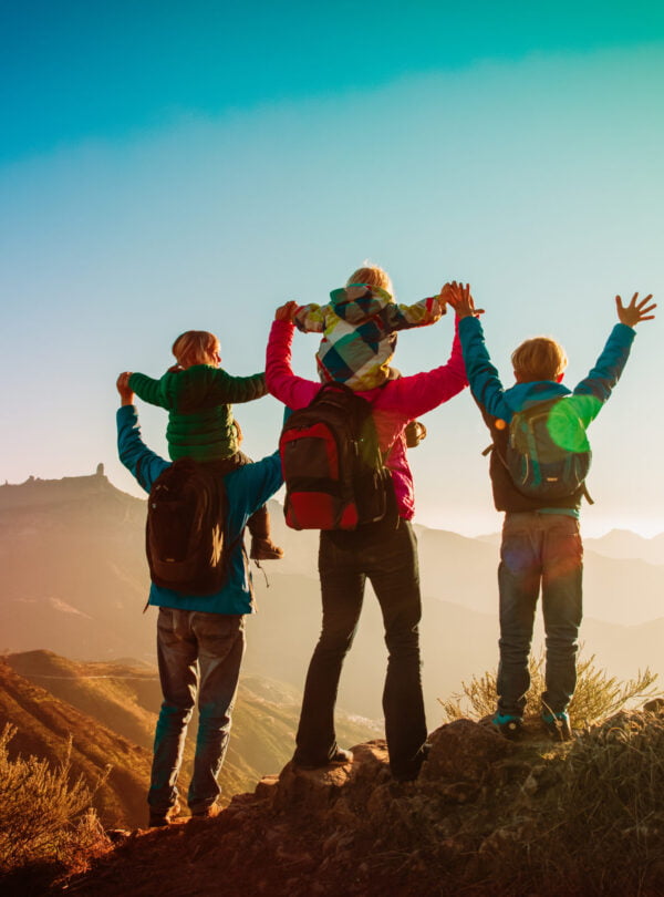 happy family travel in mountains at sunset